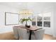 Modern dining room featuring a stylish chandelier, wood table, and large picture window at 265 S Monroe St, Denver, CO 80209