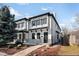 Charming home with manicured landscaping, black trim, and an inviting entrance at 265 S Monroe St, Denver, CO 80209