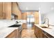 Bright kitchen features light wood cabinets, stainless steel appliances and white countertops at 265 S Monroe St, Denver, CO 80209