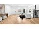 Bright living room with hardwood floors, stylish furnishings, and ample natural light from large windows at 265 S Monroe St, Denver, CO 80209