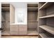 Organized walk-in closet with custom shelving and drawers, offering ample storage space at 265 S Monroe St, Denver, CO 80209