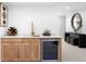 Basement wet bar with wine fridge, modern lighting, and a marble countertop at 265 S Monroe St, Denver, CO 80209