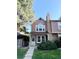 Charming two-story home featuring a stone chimney, well-manicured lawn, and inviting front entrance at 1240 S Flower Cir # A, Lakewood, CO 80232