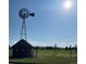 Charming windmill feature with storage building on property grounds and views of open green space in the background at 1240 S Flower Cir # A, Lakewood, CO 80232