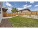 Landscaped backyard with grassy area and wooden fence at 2008 Galapago, Denver, CO 80223