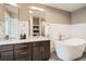 Modern bathroom with double vanity and a free-standing bathtub at 2008 Galapago, Denver, CO 80223