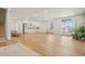 Large finished basement featuring light wood floors, stainless fridge, bar sink, and natural light from the stairwell windows at 3197 Cool Meadow Pl, Castle Rock, CO 80104