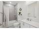 Bright bathroom featuring a tub and shower combination with gray tiling and patterned floor at 3197 Cool Meadow Pl, Castle Rock, CO 80104