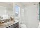 Modern bathroom showcasing a glass-enclosed shower, granite countertop, and natural light from a window at 3197 Cool Meadow Pl, Castle Rock, CO 80104