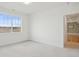 Light-filled bedroom with plush carpet and a large window with views of the rolling hills outside at 3197 Cool Meadow Pl, Castle Rock, CO 80104