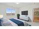 Bedroom with a queen-sized bed, white dresser, and large window providing natural light and views of the hills at 3197 Cool Meadow Pl, Castle Rock, CO 80104