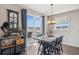 Cozy dining area with hardwood floors, a modern chandelier, and sliding glass doors to a deck at 3197 Cool Meadow Pl, Castle Rock, CO 80104