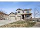 Inviting two-story home with a three-car garage and charming front porch, set against a scenic backdrop at 3197 Cool Meadow Pl, Castle Rock, CO 80104