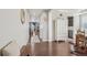 Hallway showcasing hardwood floors, a decorative hutch, and a view into the dining and living areas at 3197 Cool Meadow Pl, Castle Rock, CO 80104