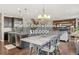 Open kitchen and dining area with stainless appliances, granite countertops, and hardwood floors at 3197 Cool Meadow Pl, Castle Rock, CO 80104