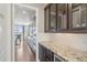 Gourmet kitchen boasts custom cabinetry, granite countertops, and seamless access to a pantry and dining room at 3197 Cool Meadow Pl, Castle Rock, CO 80104