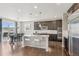 Modern kitchen and dining area with stainless appliances, granite countertops, and hardwood floors at 3197 Cool Meadow Pl, Castle Rock, CO 80104