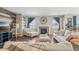 Comfortable living room features a fireplace, ample natural light, and a relaxing atmosphere at 3197 Cool Meadow Pl, Castle Rock, CO 80104