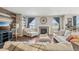 Bright living room featuring a fireplace, hardwood floors, and elegant decor at 3197 Cool Meadow Pl, Castle Rock, CO 80104