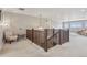 Bright loft space with neutral carpet, decorative lighting, and view of the staircase below at 3197 Cool Meadow Pl, Castle Rock, CO 80104