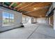 Unfinished basement featuring concrete floors, exposed ceiling, and large windows offering natural light and views at 3399 Backdrop Ct, Castle Rock, CO 80108