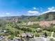 Stunning aerial view of a golf course community surrounded by beautiful red rock formations and lush greenery at 6980 Fargo Trl, Littleton, CO 80125