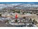 Aerial view of townhomes surrounded by snow-covered landscape and trees on a sunny winter day at 6980 Fargo Trl, Littleton, CO 80125