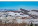 Aerial view showcasing snowy mountain and building landscape at 6980 Fargo Trl, Littleton, CO 80125