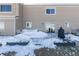 Back patio with snow, partially covered deck, and grill at 6980 Fargo Trl, Littleton, CO 80125