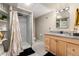 Basement bathroom with vanity, shower, and light wood cabinets at 6980 Fargo Trl, Littleton, CO 80125