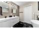 Modern bathroom features double vanity, sleek fixtures, and eye-catching floor tile at 6980 Fargo Trl, Littleton, CO 80125