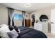 Bright bedroom with a queen-size bed, dresser, and window offering an outdoor view at 6980 Fargo Trl, Littleton, CO 80125