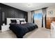 Spacious main bedroom with a large bed, nightstands, and a stunning geometric accent wall at 6980 Fargo Trl, Littleton, CO 80125