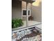 Charming deck area with manicured rock details, landscaping, and a planter with vibrant red flowers at 6980 Fargo Trl, Littleton, CO 80125
