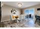 Dining area with natural light and mountain views, modern table with seating for six, and luxury vinyl plank flooring at 6980 Fargo Trl, Littleton, CO 80125