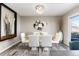 Bright dining room featuring a glass table, modern chairs, and contemporary chandelier at 6980 Fargo Trl, Littleton, CO 80125