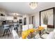 Modern dining room with glass table and view into updated kitchen at 6980 Fargo Trl, Littleton, CO 80125