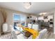 Bright dining room showcases mountain views and adjoins a modern kitchen with gray cabinets at 6980 Fargo Trl, Littleton, CO 80125