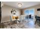 Stylish dining room with modern chandelier, sleek furnishings, and sliding glass doors with scenic views at 6980 Fargo Trl, Littleton, CO 80125