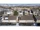 Exterior view showcasing well-maintained townhomes, each with private garages, set against a snowy backdrop at 6980 Fargo Trl, Littleton, CO 80125