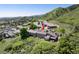 Aerial view of townhome showing back patio, fence, and mountain views in golf course community at 6980 Fargo Trl, Littleton, CO 80125