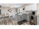 Modern kitchen with gray and white cabinets and granite countertop at 6980 Fargo Trl, Littleton, CO 80125