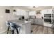 Bright kitchen features gray and white cabinetry, stainless appliances, and breakfast bar at 6980 Fargo Trl, Littleton, CO 80125