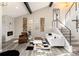 Open-concept living room boasting vaulted ceilings, modern decor, and staircase at 6980 Fargo Trl, Littleton, CO 80125