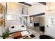 Bright living room boasts soaring ceilings, an open staircase, and contemporary decor at 6980 Fargo Trl, Littleton, CO 80125