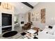 Chic living room with vaulted ceilings, modern fireplace, stylish decor, and sleek, hardwood flooring at 6980 Fargo Trl, Littleton, CO 80125