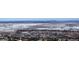 Expansive neighborhood view with a glimpse of the city skyline in the distance, blending urban and natural landscapes at 6980 Fargo Trl, Littleton, CO 80125