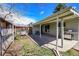 Backyard view with fenced yard, patio, grill, and bench seating, perfect for outdoor enjoyment and relaxation at 7240 S Cherry Dr, Centennial, CO 80122