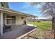 Outdoor patio extending to a grassy yard, complete with a grill, sliding glass door, and views of the surroundings at 7240 S Cherry Dr, Centennial, CO 80122