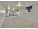 Finished basement with carpet, built-in shelving, and natural light at 7240 S Cherry Dr, Centennial, CO 80122